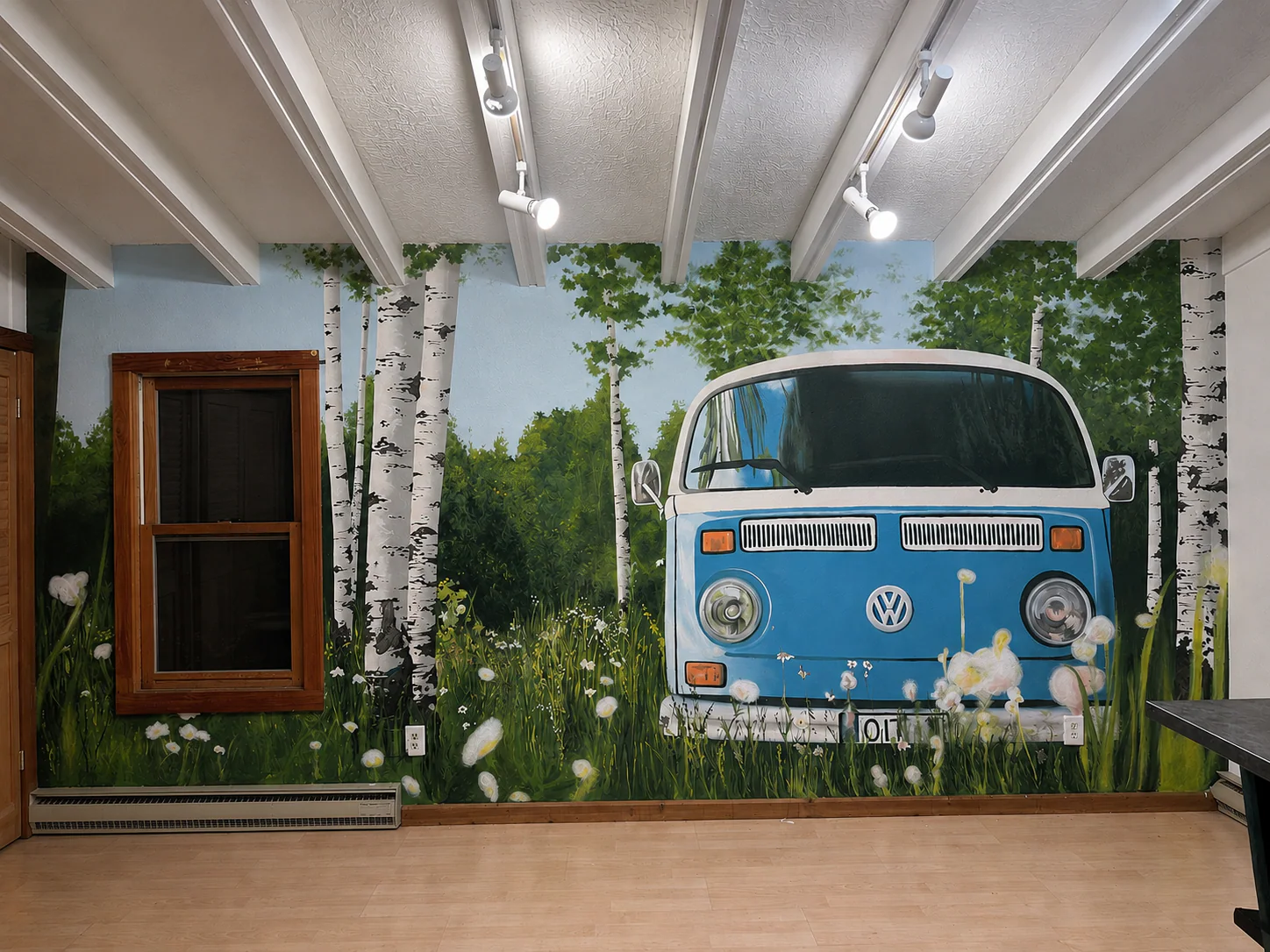 Interior mural of a blue Volkswagen bus surrounded by birch trees, grasses, and wildflowers