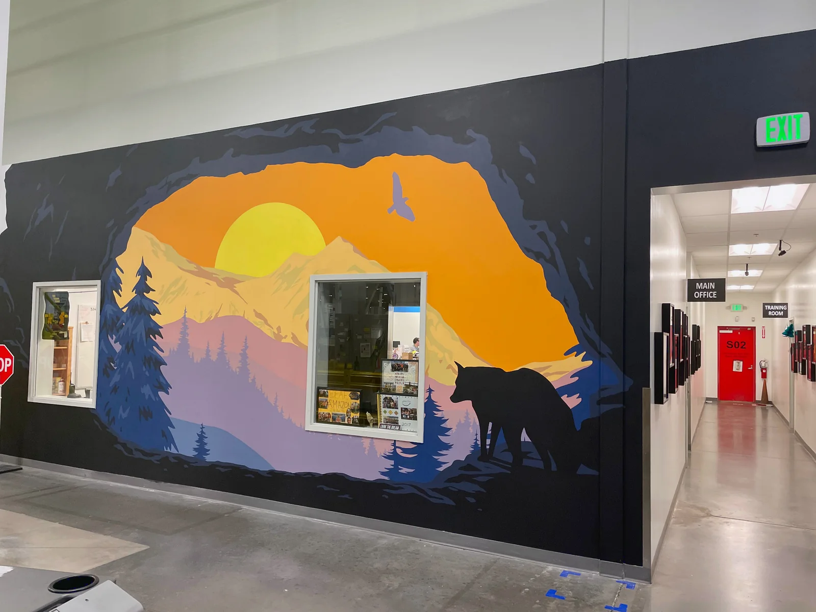 Closer view of the Wolf Den mural wrapping around an interior window and doorway